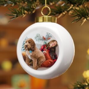 Ball Christmas ornament with dog and young girl hanging on christmas tree
